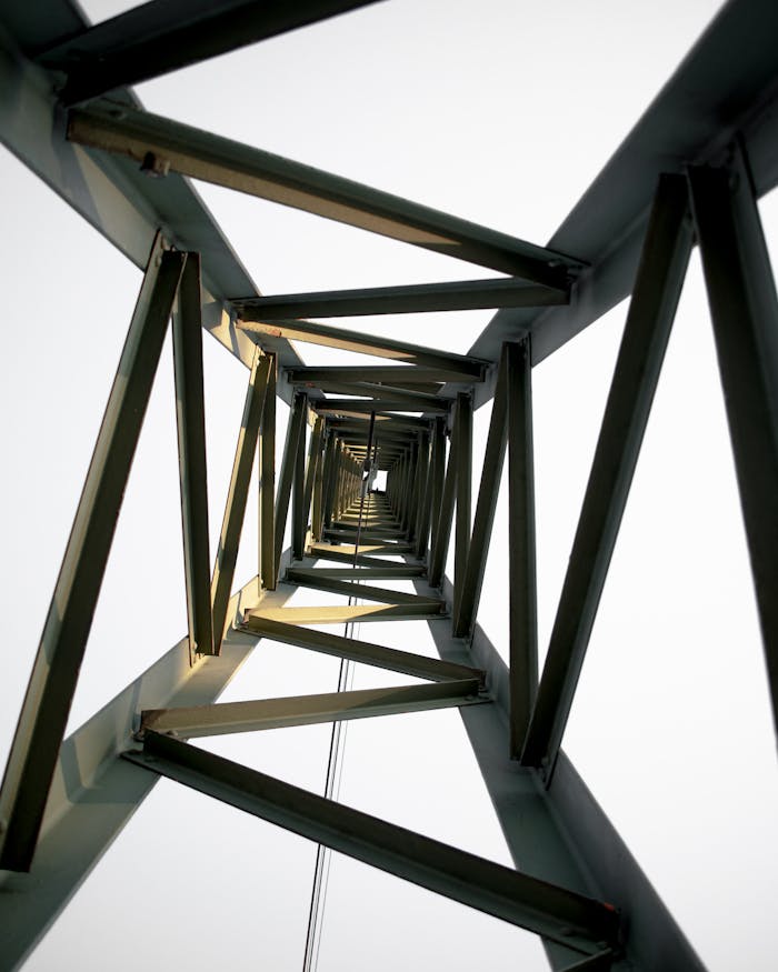 gallery-4 Dramatic view from inside a steel tower showcasing architectural geometry.