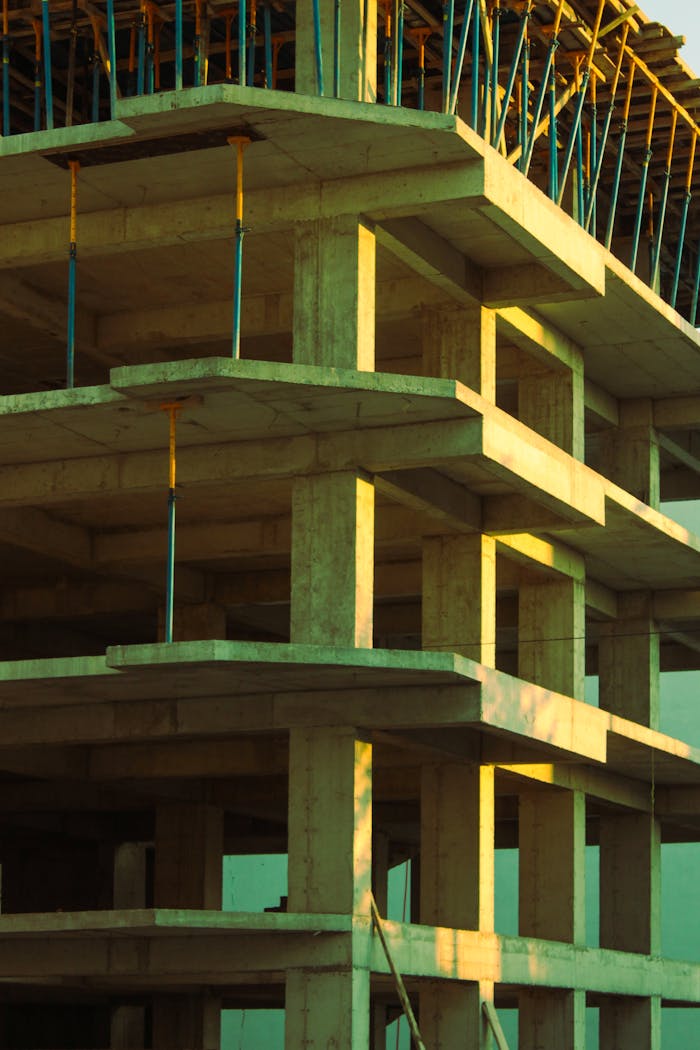 services-01 Concrete building structure in early stages of construction captured at sunset, showcasing architectural framework.